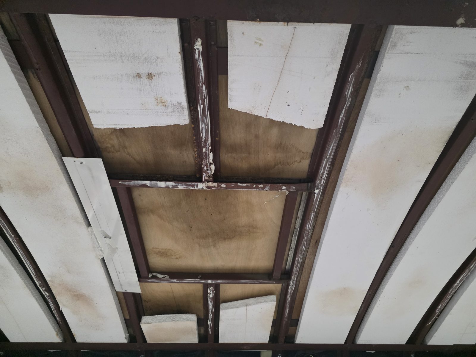 Original roof structure and ceiling framing exposed inside the body