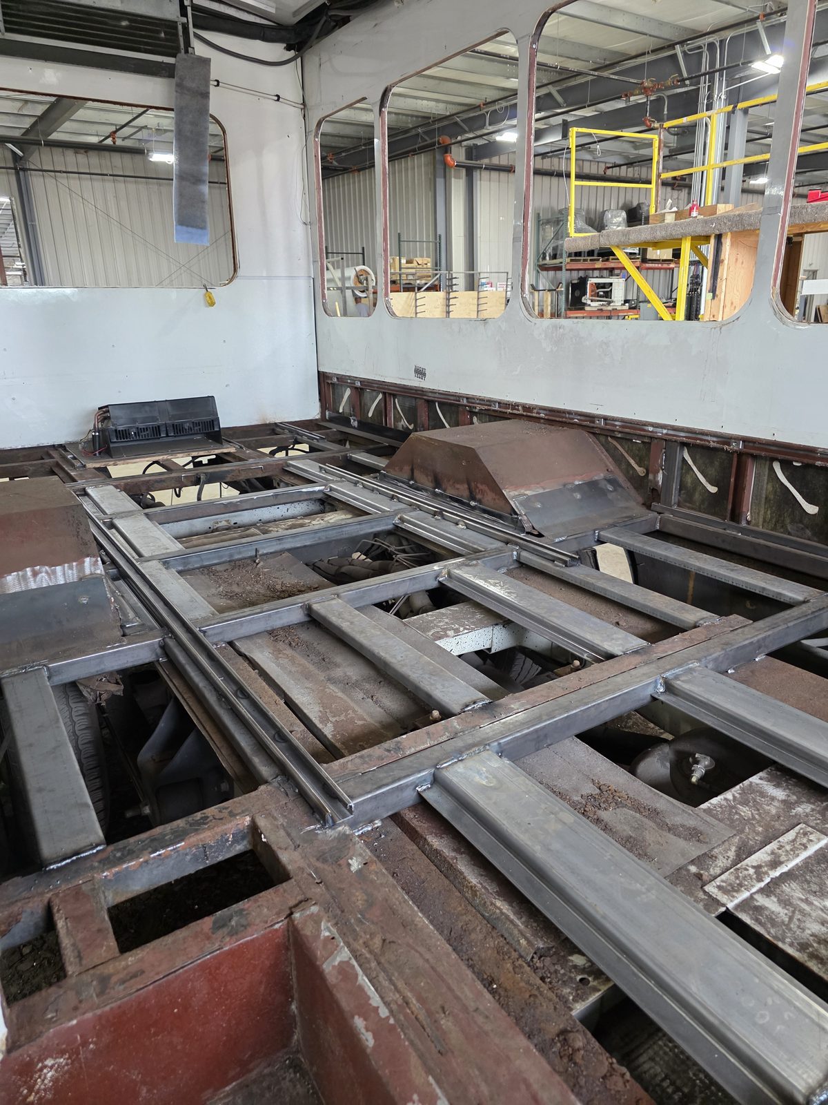 Floor structure exposed with the decking removed, seen from the rear of the bus